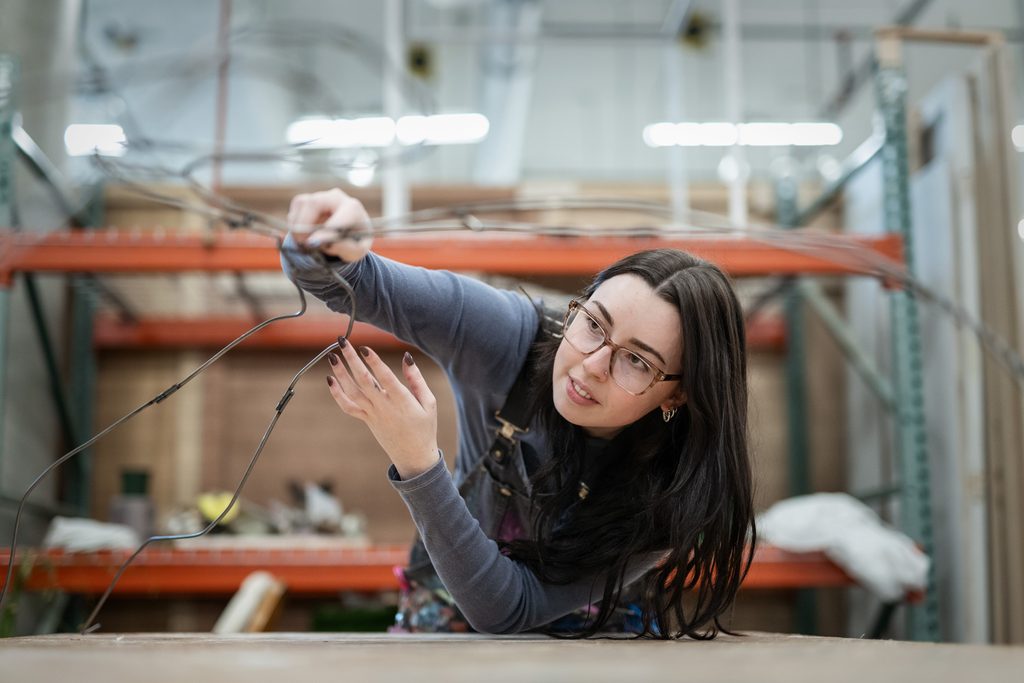 Students working on creative projects in a studio workspace at Emily Carr University