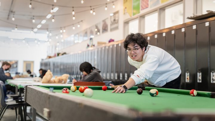 Student recreation and social space at Emily Carr University with a billiards table and study areas.