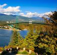 Scenic view of Vancouver featuring the Lions Gate Bridge, waterfront and surrounding mountains